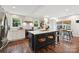Open concept kitchen with a center island, breakfast bar, stainless steel appliances, and bright windows at 829 Sedgefield Rd, Charlotte, NC 28209