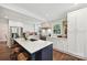 Charming kitchen boasts an island with seating, stainless appliances, and lots of natural light at 829 Sedgefield Rd, Charlotte, NC 28209