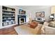Open living room with a cozy fireplace, hardwood floors, and stylish decor at 829 Sedgefield Rd, Charlotte, NC 28209