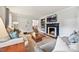 Comfortable living room featuring hardwood floors, fireplace, and plenty of natural light at 829 Sedgefield Rd, Charlotte, NC 28209
