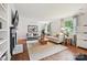 Bright living room with hardwood floors, fireplace, and two comfortable sofas at 829 Sedgefield Rd, Charlotte, NC 28209