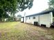 Spacious backyard with a white brick home, chimney, and AC unit at 901 Echo Glen Rd, Charlotte, NC 28213