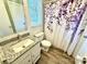 Well-maintained bathroom with modern fixtures, granite vanity, and a shower with a purple floral curtain at 901 Echo Glen Rd, Charlotte, NC 28213
