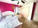 Bright bedroom with a playful pink accent wall, plush carpet, and ample storage space at 901 Echo Glen Rd, Charlotte, NC 28213