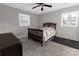Comfortable bedroom featuring a ceiling fan, two windows, and neutral carpeting at 901 Echo Glen Rd, Charlotte, NC 28213