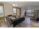 Open dining room with brick fireplace, modern light fixture, and adjoined kitchen area at 901 Echo Glen Rd, Charlotte, NC 28213