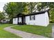 A charming white brick home featuring a well-kept lawn and a quaint front porch at 901 Echo Glen Rd, Charlotte, NC 28213