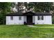 Charming brick home featuring a cozy front porch and a well-manicured lawn at 901 Echo Glen Rd, Charlotte, NC 28213