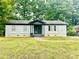 Charming single-story home with a freshly painted white brick exterior and well-maintained front lawn at 901 Echo Glen Rd, Charlotte, NC 28213