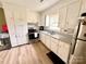 Well-lit kitchen featuring stainless steel appliances, white cabinets, and granite countertops at 901 Echo Glen Rd, Charlotte, NC 28213