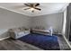 Cozy living room featuring stylish sofas, a modern ceiling fan, and wood-look flooring at 901 Echo Glen Rd, Charlotte, NC 28213