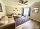 Inviting living room with light wood flooring, two cozy couches, and a view of the outdoors at 901 Echo Glen Rd, Charlotte, NC 28213