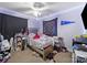 Cozy bedroom featuring a ceiling fan and wall decorations at 1004 E 8Th Ave, Gastonia, NC 28054