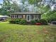 Charming single-story home with a well-maintained front yard, framed by mature trees providing ample shade at 1004 E 8Th Ave, Gastonia, NC 28054