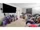 Spacious living room featuring a comfortable sofa, large screen TV, and neutral carpet at 1004 E 8Th Ave, Gastonia, NC 28054