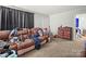 Spacious living room featuring a comfortable sofa and neutral carpet at 1004 E 8Th Ave, Gastonia, NC 28054