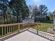 This backyard features a wooden deck overlooking a large green area, storage shed and lots of trees at 1038 Gold Mine Dr, Catawba, NC 28609