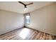 Bright bedroom with wood look flooring, ceiling fan, and window with natural light shining into the room at 1038 Gold Mine Dr, Catawba, NC 28609