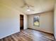 Cozy bedroom with wood look flooring, ceiling fan and a bright window overlooking the outdoor scenery at 1038 Gold Mine Dr, Catawba, NC 28609