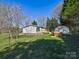 Shows home with gray siding, a small wooden deck, and green lawn surrounded by trees at 1038 Gold Mine Dr, Catawba, NC 28609