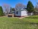 Shows single-story home with gray siding, a wooden deck, green lawn, and a storage shed at 1038 Gold Mine Dr, Catawba, NC 28609