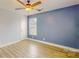 Bedroom featuring blue accent wall, modern ceiling fan, and light hardwood flooring at 108 Devynne Ct, Salisbury, NC 28146