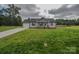 Charming single-story home with a well-manicured lawn, attached garage, and inviting front porch at 108 Devynne Ct, Salisbury, NC 28146