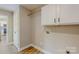 Laundry Room featuring upper cabinets, hanging bar, and washer/dryer hookups at 108 Devynne Ct, Salisbury, NC 28146