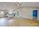 Spacious open layout with wood-look flooring, vaulted ceiling, and ample natural light in the living area at 108 Devynne Ct, Salisbury, NC 28146