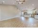 Bright open-concept layout with wood-look flooring, vaulted ceiling, and seamless flow into the modern kitchen at 108 Devynne Ct, Salisbury, NC 28146
