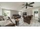 Inviting living room with neutral walls, ceiling fan, and comfortable brown furniture, perfect for relaxing and entertaining at 110 Crescent Heights Dr, Salisbury, NC 28146