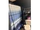 A bathroom with a striped shower curtain, toilet, and rack for storing towels at 114 Wayne Ave, Kannapolis, NC 28081