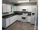 Bright kitchen featuring white cabinets, granite countertops, and stainless steel appliances at 12 Watts St, York, SC 29745
