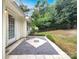 Relax on this beautiful back patio with custom tile work and view of a peaceful backyard at 12307 Poplar Forest Dr, Charlotte, NC 28278