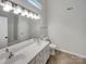 Bright bathroom featuring a double sink vanity, large mirror, and modern fixtures at 12307 Poplar Forest Dr, Charlotte, NC 28278