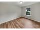 Bedroom showcasing a large window, wood floors, and a neutral color scheme at 12307 Poplar Forest Dr, Charlotte, NC 28278