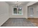 Bright dining room featuring gray tile, a window with backyard view, and stylish lighting at 12307 Poplar Forest Dr, Charlotte, NC 28278