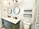 Modern bathroom with double vanity, marble countertop, black fixtures, and round mirrors at 125 Todd Nw Dr, Concord, NC 28025