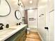 Modern bathroom with double vanity, marble countertop, black fixtures, and tiled shower with tub at 125 Todd Nw Dr, Concord, NC 28025