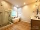 Modern bathroom with walk-in shower, free-standing tub, and double sink vanity at 125 Todd Nw Dr, Concord, NC 28025