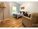 Relaxing bedroom with hardwood floors, neutral walls, accent chair, and a comfortable bed at 125 Todd Nw Dr, Concord, NC 28025
