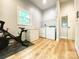 Bonus room featuring a Peloton bike, a freezer, and laundry appliances at 125 Todd Nw Dr, Concord, NC 28025