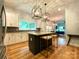 Kitchen with white cabinets, stainless steel appliances, island with seating, and open floor plan at 125 Todd Nw Dr, Concord, NC 28025