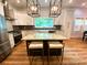 Beautiful kitchen features granite countertops, island with seating, stainless steel appliances, and modern lighting at 125 Todd Nw Dr, Concord, NC 28025