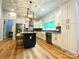 Bright kitchen featuring white cabinets, stainless steel appliances, island with seating, and modern light fixtures at 125 Todd Nw Dr, Concord, NC 28025