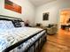 Spacious main bedroom with hardwood floors, neutral walls, a comfortable bed, and two accent chairs at 125 Todd Nw Dr, Concord, NC 28025
