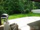 Grill and entertain in the backyard with a spacious stone patio and lush green landscape at 1311 Stonecroft Nw Ln, Concord, NC 28027