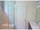 Bathroom featuring a frameless glass shower door and white vanity with a dark cabinet at 1311 Stonecroft Nw Ln, Concord, NC 28027