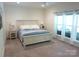 Spacious bedroom featuring neutral color palette, carpet flooring, and windows with sheer curtains at 1311 Stonecroft Nw Ln, Concord, NC 28027