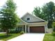 Charming one-story home featuring a two-car garage and beautifully landscaped front yard at 1311 Stonecroft Nw Ln, Concord, NC 28027
